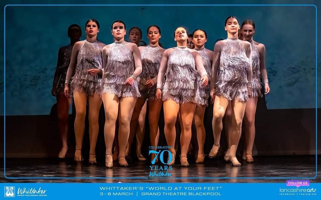 Senior tap group in silver fringed costumes celebrating 70 years at the Grand Theatre